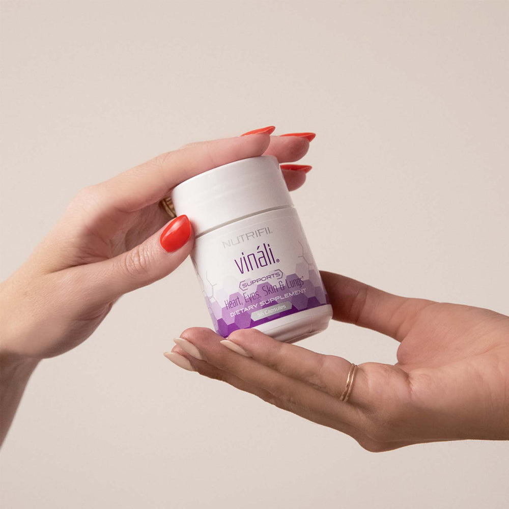 Hand holding a jar of Nutrifii Vinali